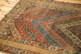 Late 19th-century Kurdish rug detail: bold cherry red and blue striped floral pattern with wide plain border.