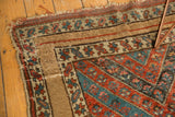 Antique Kurdish rug, late 19th century corner with wide camel border and madder red, sky blue floral motifs.