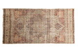 Antique Kerman rug runner, distressed scalloped medallion, floral design, ivory, cochineal red, navy.