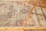 Hand-knotted antique Kerman runner, detailed floral pattern in faded red, ivory, navy, with visible pile wear.