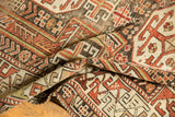 Time-softened copper, rust, brown pile showing rectilinear infinity knot patterns.