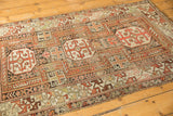 Rectilinear field patterns, infinity knots, and geometric arabesque border of an antique Caucasian rug.