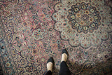 Scalloped medallion, floral vinery on vintage Meshed carpet, faded plum, pale blue, low pile.