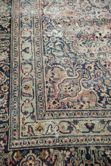 Intricate borders and faded floral vinery on vintage Meshed carpet, showing wear.
