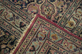 Vintage Persian Meshed carpet folded corner, showing plum-edged floral border, low pile.