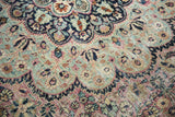 Vintage Meshed rug detail: faded plum, sky blue, ivory floral vinery, with low pile and foundation.