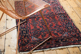 Vintage Persian Engelas rug's cherry red field with navy Herati motif and blossomed wool pile.