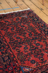 Cherry red field and navy Herati motifs on a hand-knotted vintage Engelas rug.