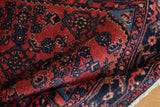 Textured cherry red pile with Herati motifs and navy samovar border on a vintage Engelas rug.