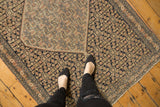 Detailed inverted coloration Herati motif on an antique Senneh rug field in navy, ivory, and blush.