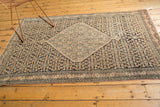 Antique Senneh rug's intricate border and Herati field pattern in navy charcoal, ivory, blush.