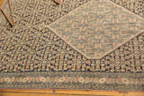 Antique Senneh rug's intricate Herati motif, navy and beige field, detailed border, even pile wear.