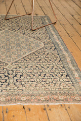 Antique Senneh rug's reciprocating Herati motif in dark navy, dusty blush, and ivory tones.