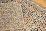 Antique Senneh rug detail: inverted Herati motifs, sharp medallion steps, navy and dusty blush.
