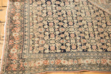 Corner detail of antique Persian Senneh rug, dusty blush Herati motif, dark navy, ivory, even wear.