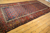 Vintage Malayer corner with cherry red borders and navy blue allover germinating floral field.