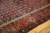Vintage Malayer carpet with intricate cherry red border, floral motifs, and aubergine edge.