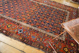 Vintage Malayer carpet with navy field's germinating florals and contrasting intricate red border.