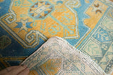 Hand-knotted foundation and distressed sky blue, gold, teal vintage Oushak rug corner.