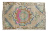 Distressed vintage Oushak rug with large medallion, lively ivory, pink, mint green, copper palette, 2'2