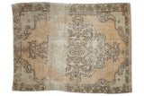 Distressed hand-knotted Oushak rug with an oversized medallion in faded beige, sand, and sage.