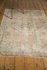 Vintage Distressed Oushak rug end with blush, ivory colors and short, secured fringe.