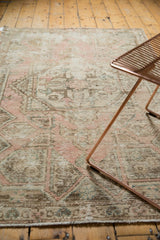 Distressed Oushak rug showing even wear to knot heads, dusty rose and ivory hues.