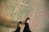 Distressed vintage Oushak rug texture with pale dusty pink, seafoam green, and even knot head wear.