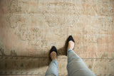 Distressed vintage Oushak rug showcasing faded blush, ivory, and seafoam green with even wear.
