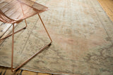Vintage distressed Oushak showing even wear with pale blush, ivory, and seafoam scrolling vinery.