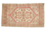 Distressed Vintage Oushak rug, dusty rose and ivory medallion with pinwheel florals.