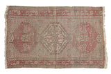 Distressed vintage Anatolian rug with geometric triple medallion design in muted wine, silver, ivory.
