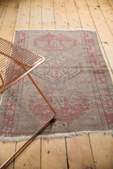 Distressed Anatolian rug, geometric hook and latch motif in faded dusty wine and silver.