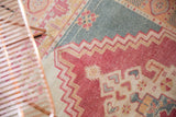 Textured vintage Oushak rug with raspberry zig-zag pattern and ocean teal.
