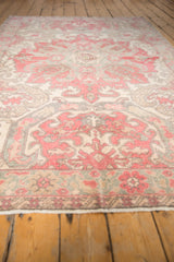 Distressed vintage Oushak carpet with classic Oushak style motifs in pale cherry and ivory.