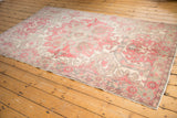 Artfully distressed corner of vintage Oushak rug, highlighting cherry and slate border.