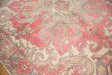Distressed Oushak carpet edge with faint foundation, revealing dusty cherry and slate blue motifs.
