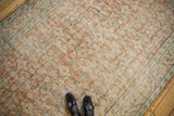 Distressed Oushak rug with apricot, ivory, and mint floral vinery, foundation showing through.