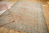 Distressed Oushak carpet, allover floral vinery in faded apricot, mint, and ivory.