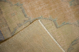 Vintage distressed Oushak rug showing worn pile texture and hand knotted reverse.