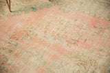 Textured distressed Oushak rug with faded dusty rose, mint green hues, and worn vinery.