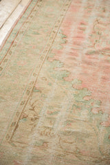 Distressed Vintage Oushak carpet pile showing foundation, soft rose and mint green.