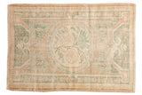 Distressed vintage Oushak rug with faded blush, seafoam, ivory medallion, 3' x 4'2