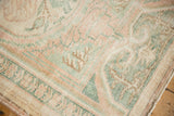 Textural detail of a distressed vintage Oushak rug, featuring soft blush, seafoam, and ivory colors.