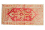 Distressed Oushak rug mat runner, bold blush medallion, ivory floral guls, low pile.