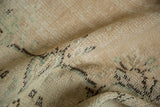 Distressed Oushak carpet pile shows even wear, faint foundation, beige, seafoam tones.