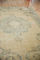 Distressed texture of vintage Oushak rug with ivory, beige, and muted seafoam blue.