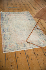 Textured vintage Oushak rug with faded blush, indigo blue, beige medallion and scrolling.