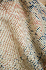 Distressed vintage Oushak rug's low pile with hand knotted beige, dusty blush, and indigo.