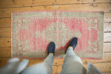 Distressed vintage Oushak runner with worn pile, faint foundation, pale pink, and seafoam.